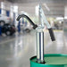 GPI BP-12 lever action steel hand pump mounted to a barrel in a garage